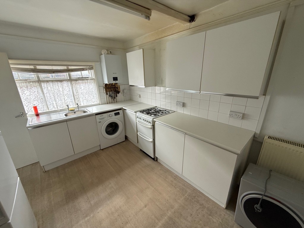 Lot: 37 - COMMERCIAL PROPERTY WITH SELF-CONTAINED SPLIT LEVEL FLAT ABOVE - Kitchen with gas boiler and window to the rear